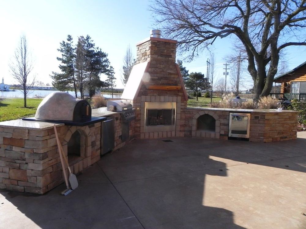 An outdoor fireplace and living space