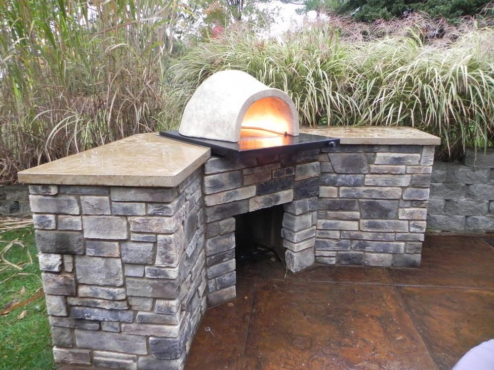 An outdoor fireplace and living space