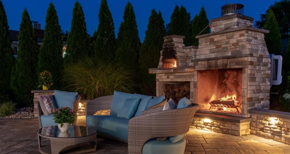 An outdoor fireplace and living space