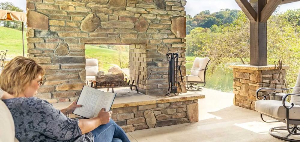 An outdoor fireplace and living space