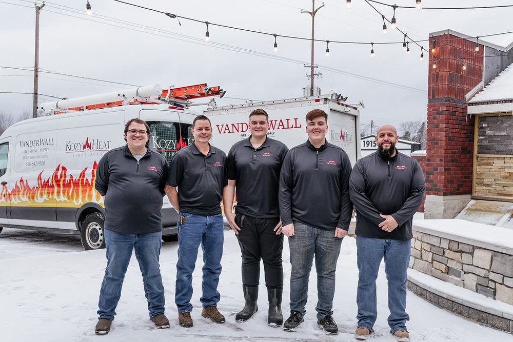 Five members of the VanderWall service team in front of a branded service van
