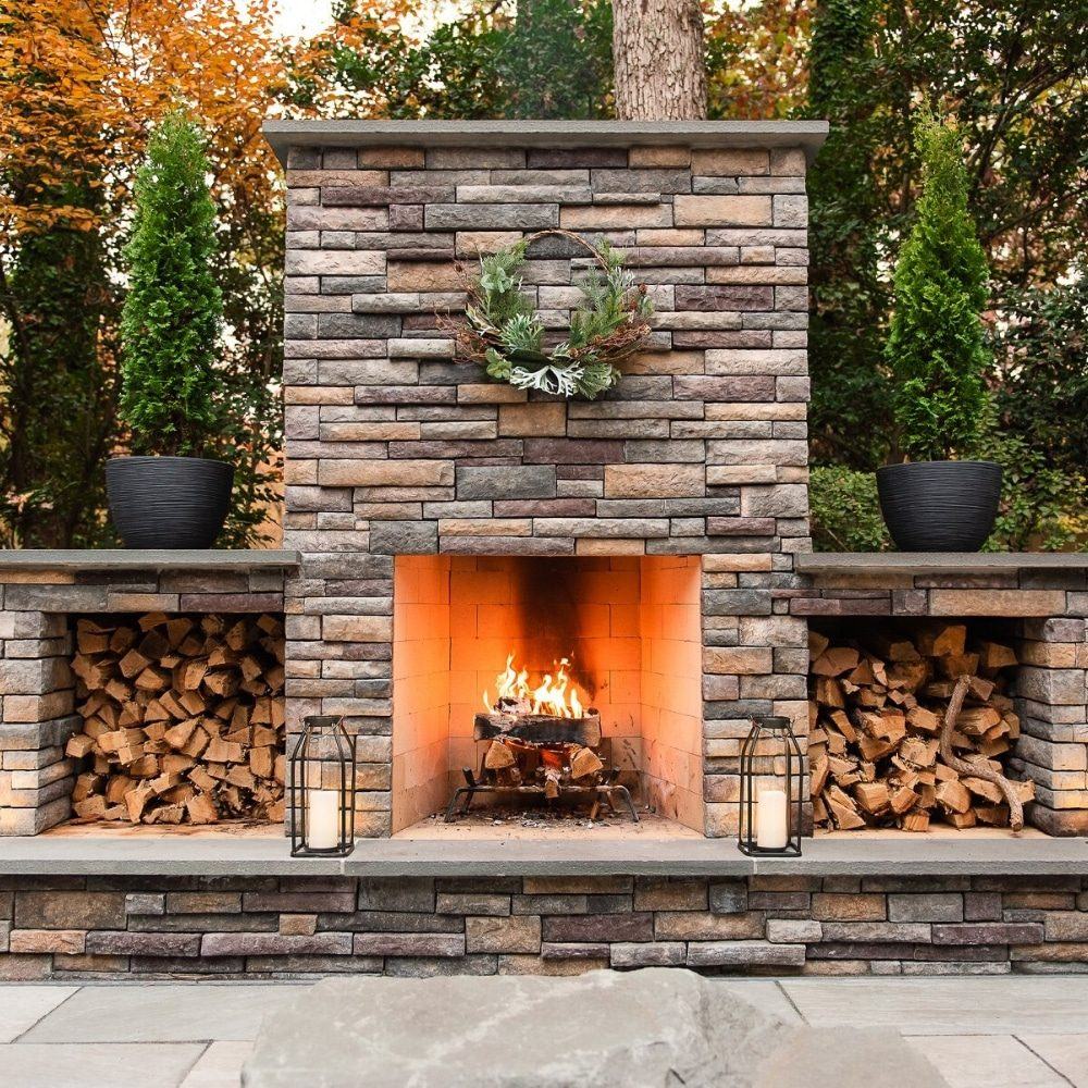 An outdoor fireplace and living space