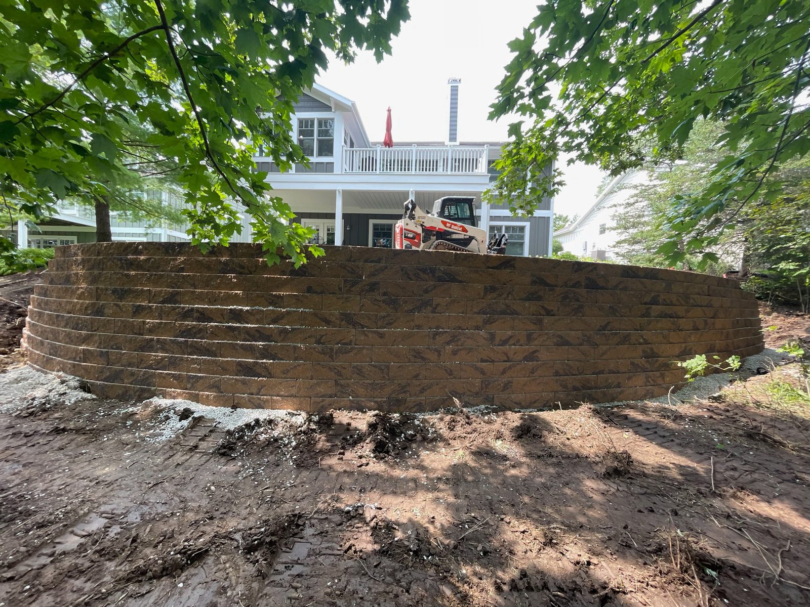 Long curved segmental retaining wall on a lakeside property