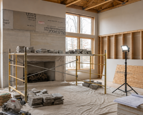 Builder preparing for fireplace installation in a West Michigan home project